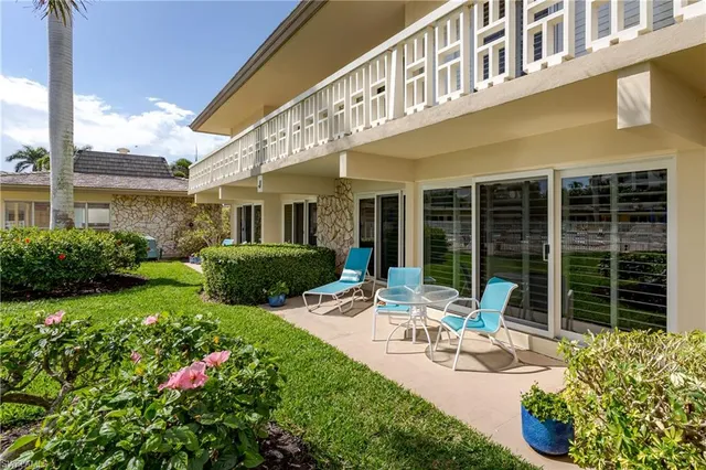 a front view of a house with porch and garden