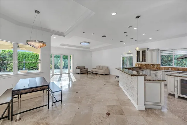 a kitchen with granite countertop a sink a counter top stainless steel appliances and cabinets