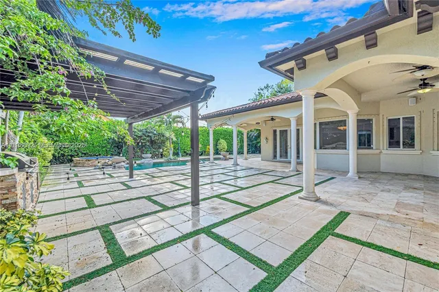 a view of a house with a big yard plants and large trees