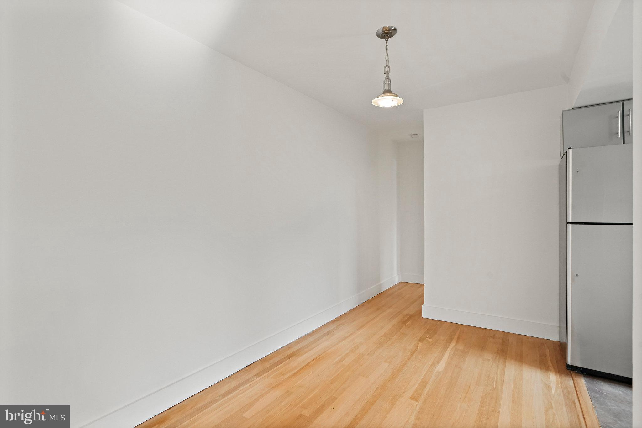 907 Euclid Street Northwest, Unit 203 Washington, DC 20001 - Photo 7 of 22 a view of empty room with wooden floor and fan