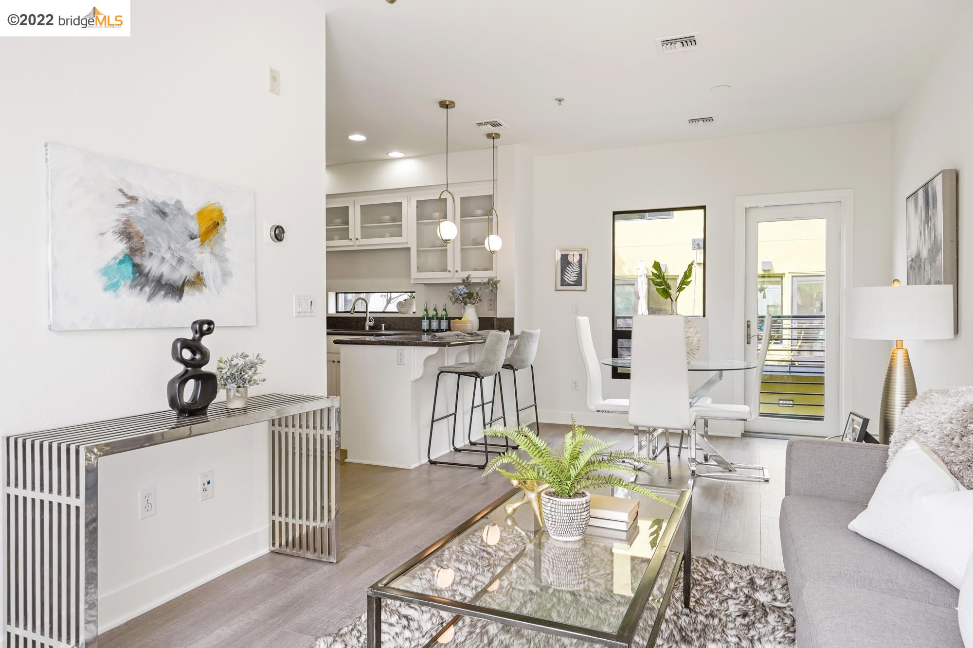 303 Zephyr Drive Oakland, CA 94607 - Photo 1 of 1 a living room with furniture and a large window