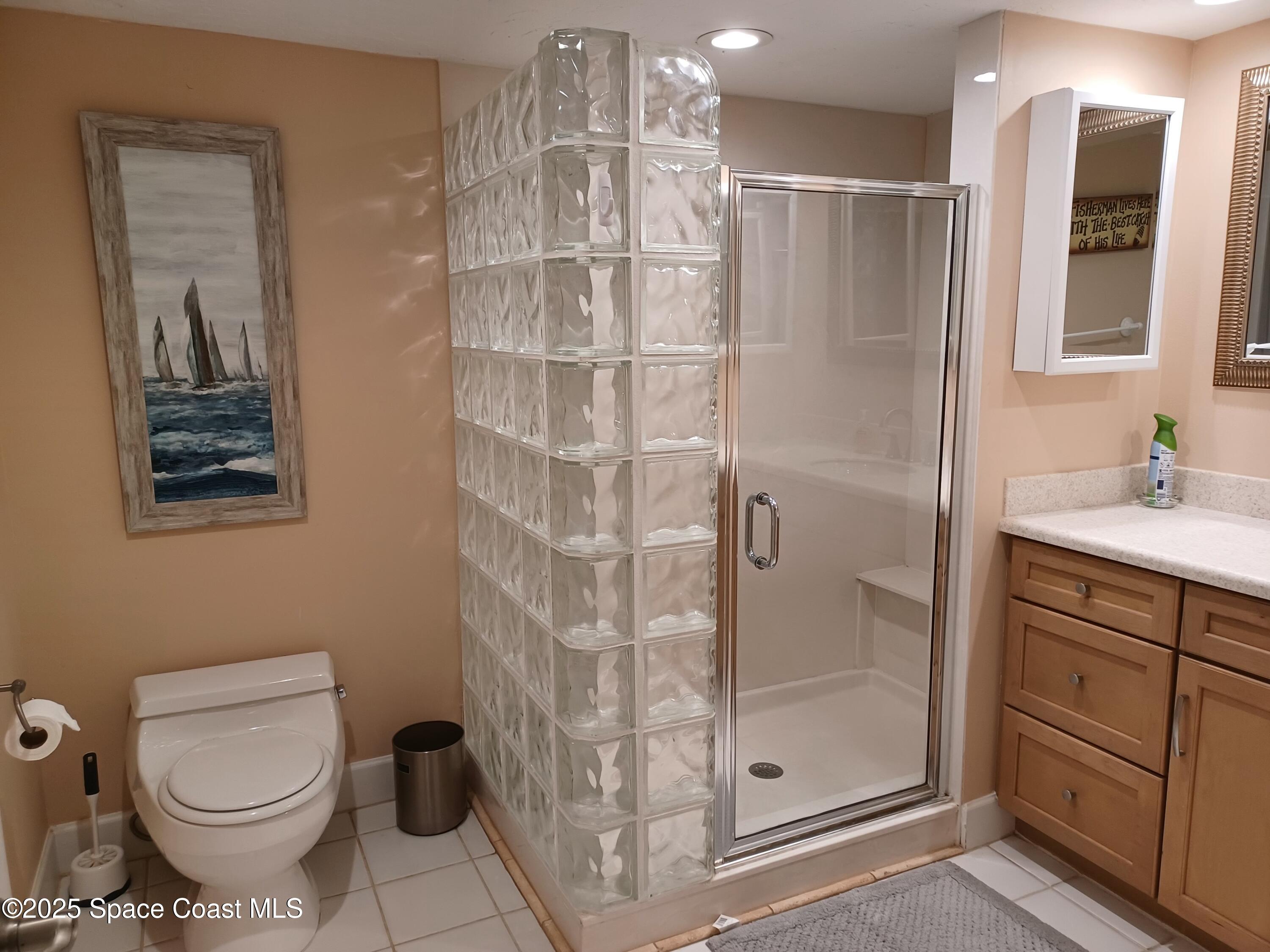 2100 North Atlantic Avenue, Unit 901 Cocoa Beach, FL 32931 - Photo 19 of 54 a bathroom with a shower toilet and sink