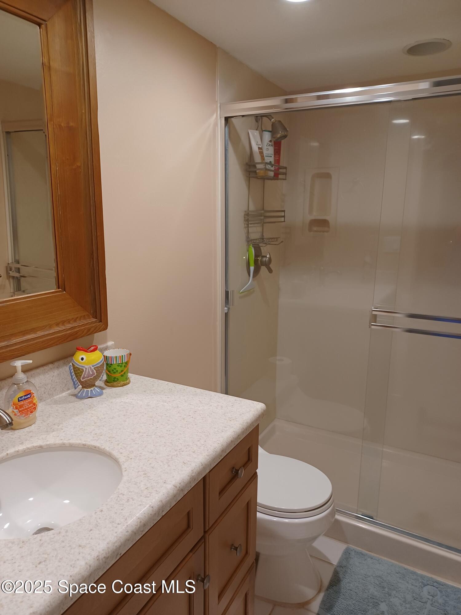 2100 North Atlantic Avenue, Unit 901 Cocoa Beach, FL 32931 - Photo 23 of 54 a bathroom with a sink toilet and shower