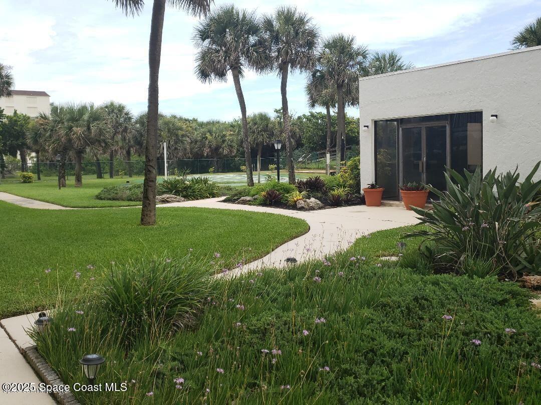 2100 North Atlantic Avenue, Unit 901 Cocoa Beach, FL 32931 - Photo 31 of 54 a view of a backyard with palm trees