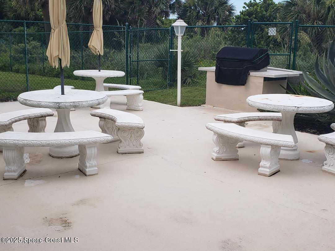 2100 North Atlantic Avenue, Unit 901 Cocoa Beach, FL 32931 - Photo 32 of 54 a view of a patio with couple of chairs and a fountain