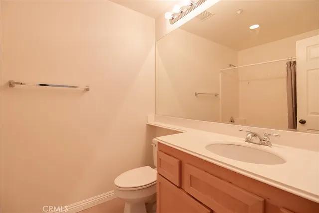 a bathroom with a sink toilet and vanity