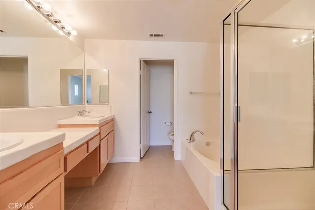 a bathroom with a tub sink and mirror