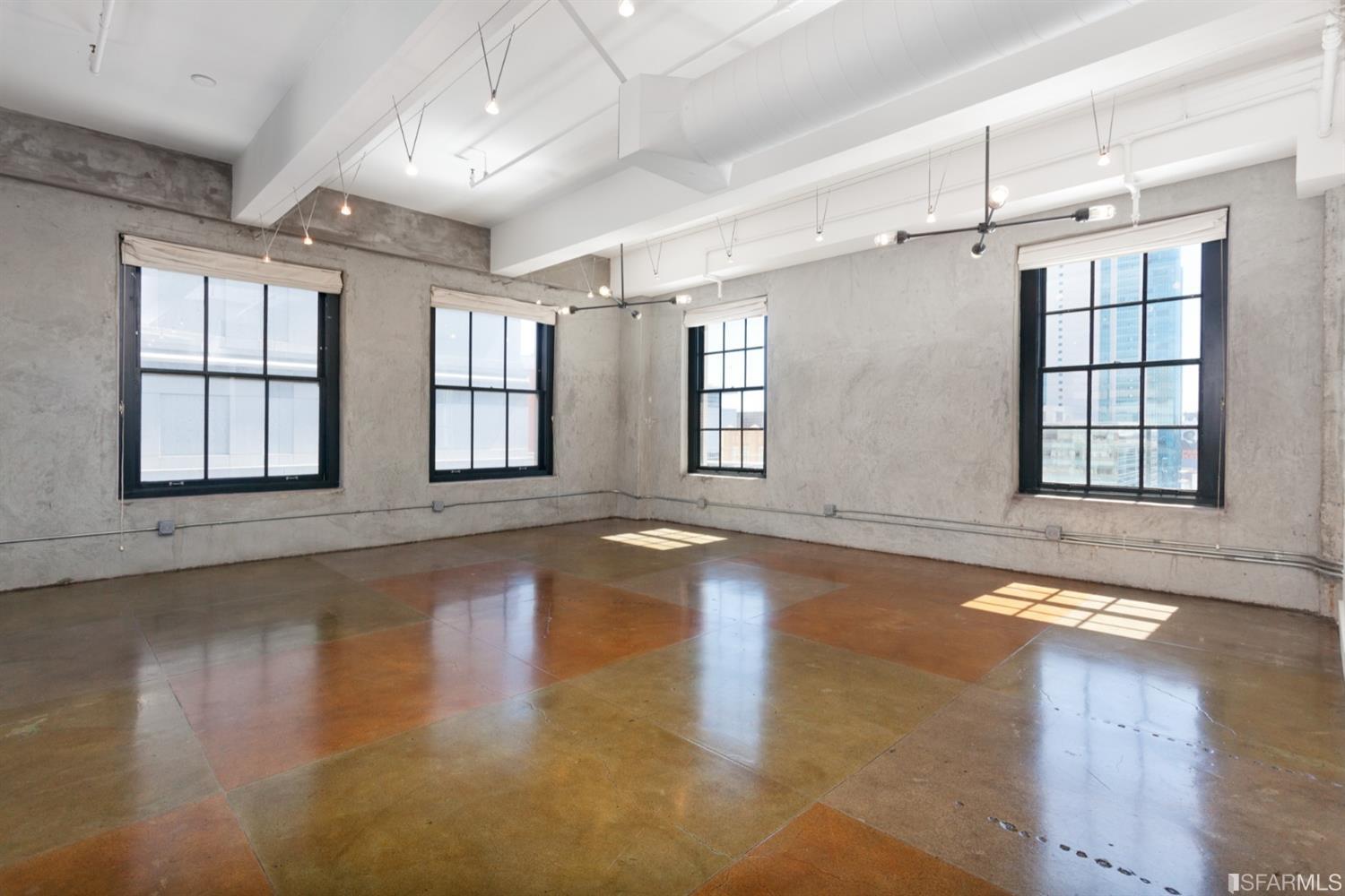 2 Mint Plaza, Unit 801 San Francisco, CA 94103 - Photo 9 of 28 a view of an empty room with chandelier fan and wooden floor