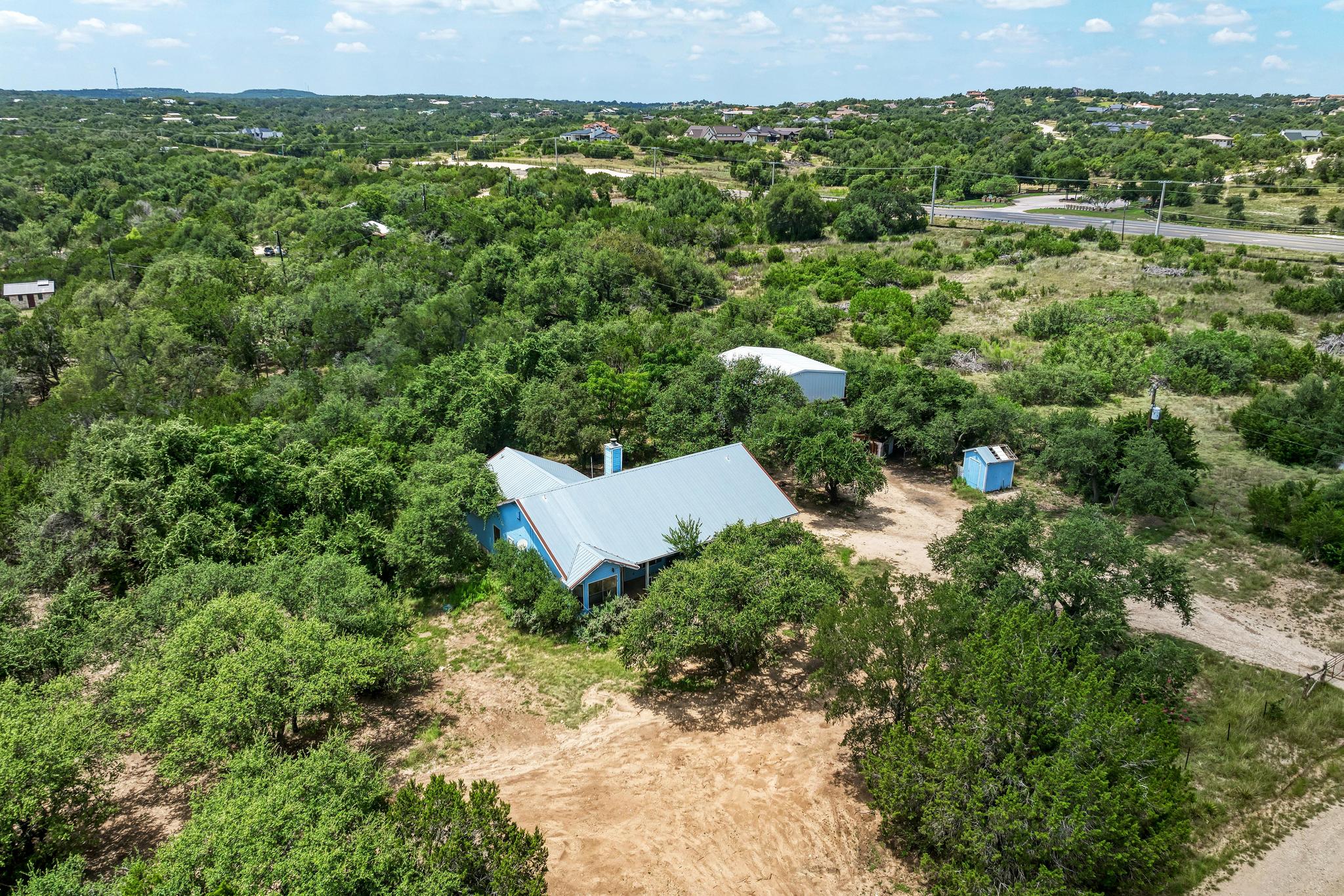 Beyond the home, the acreage is the real prize, with mature trees, open clearings, and room to expand.