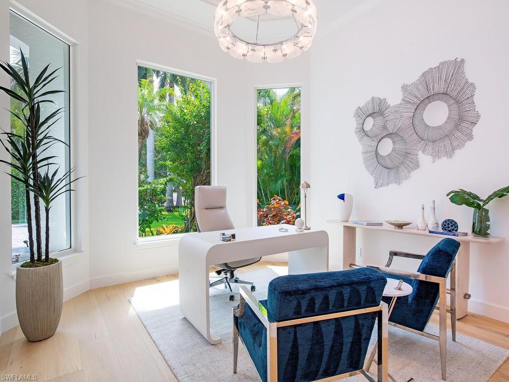 2363 Crayton Road Naples, FL 34103 - Photo 19 of 30 Dedicated room featuring light wood-finish flooring, white walls, and an ornate ceiling fixture