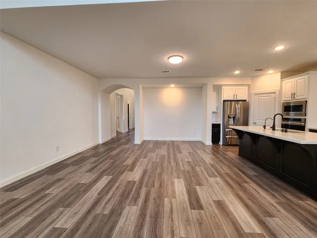 a view of kitchen with wooden floor and electronic appliances