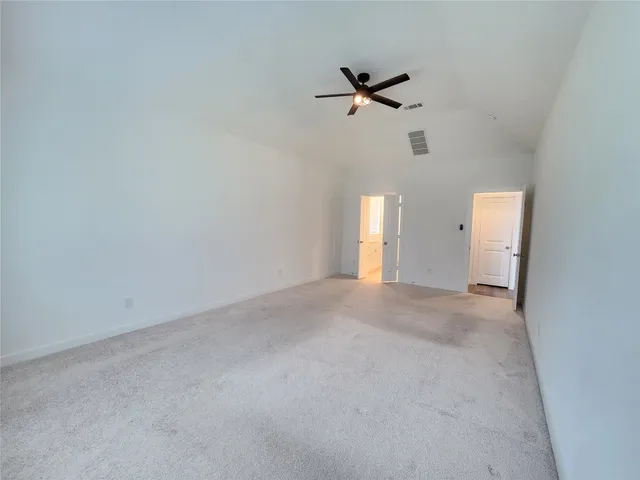 a view of a room with a ceiling fan