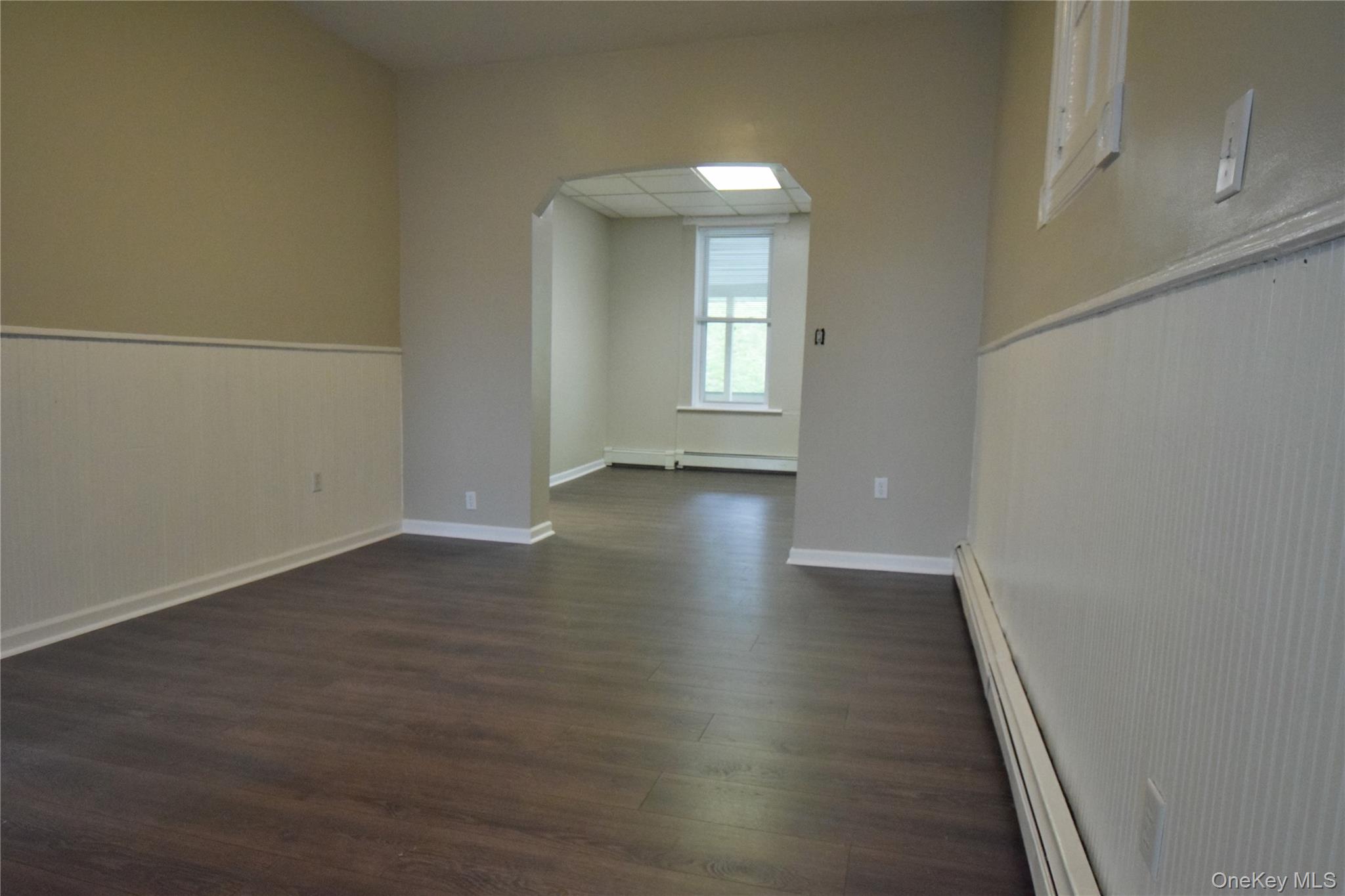 12 Railroad Avenue, Unit 2 Chester, NY 10918 - Photo 3 of 12 an empty room with wooden floor and windows