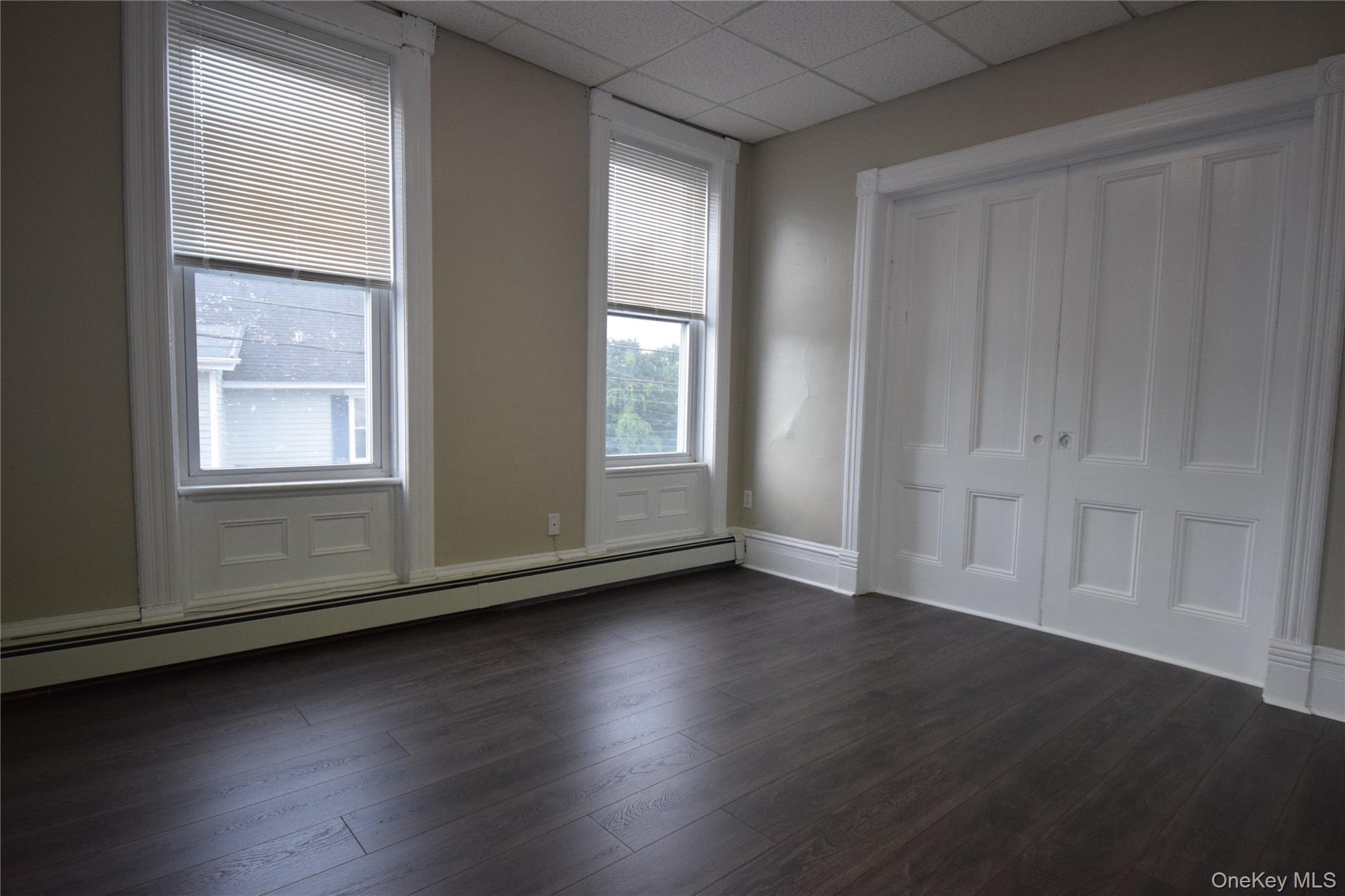 12 Railroad Avenue, Unit 2 Chester, NY 10918 - Photo 4 of 12 an empty room with wooden floor and windows
