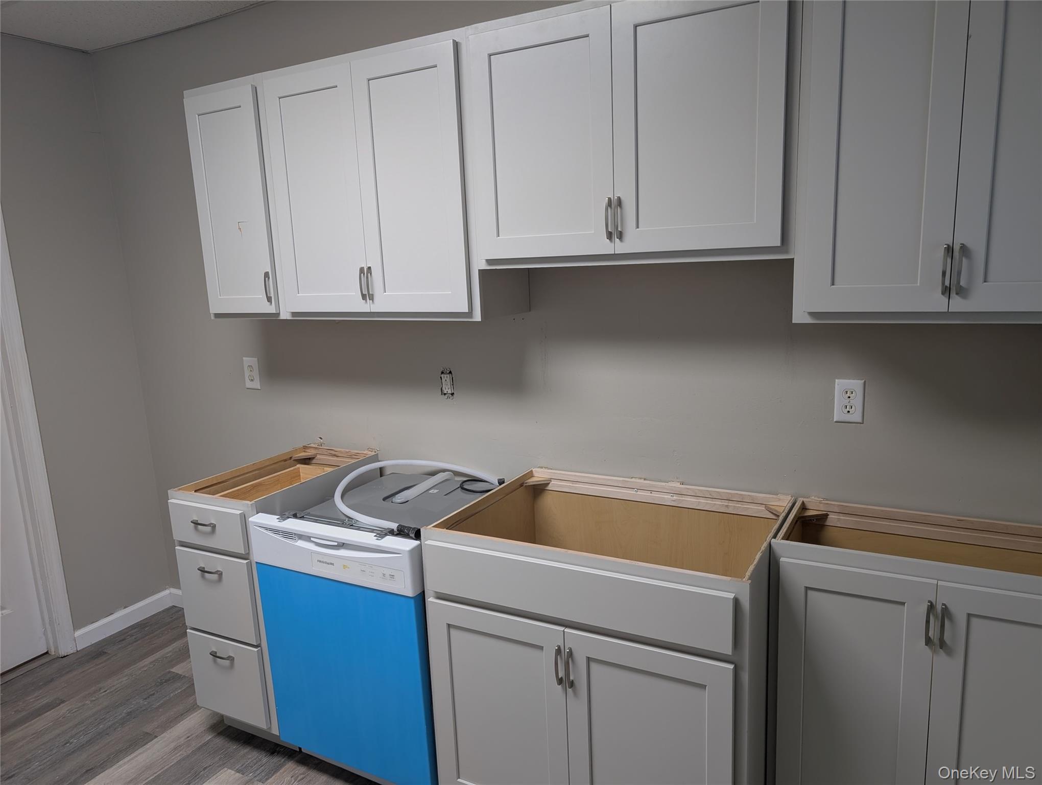 12 Railroad Avenue, Unit 2 Chester, NY 10918 - Photo 9 of 12 a kitchen with stainless steel appliances granite countertop white cabinets sink and granite countertops