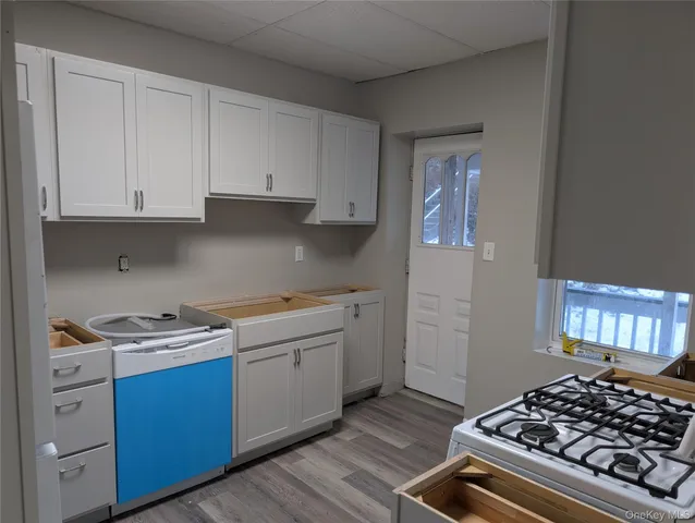 a kitchen with a stove and white cabinets