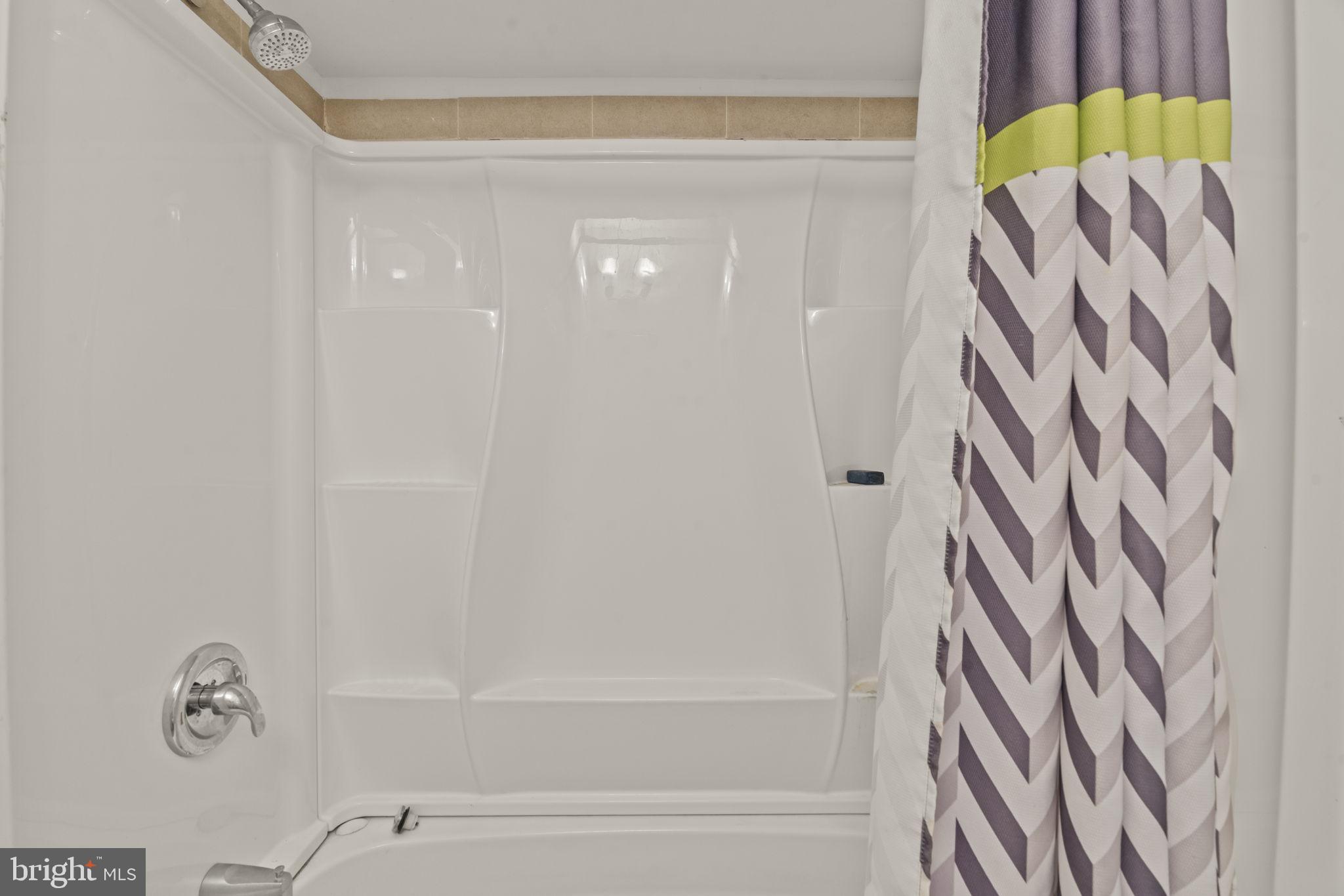 432 North Coles Avenue Maple Shade, NJ 08052 - Photo 13 of 27 a bathroom with a shower curtain and a bathtub