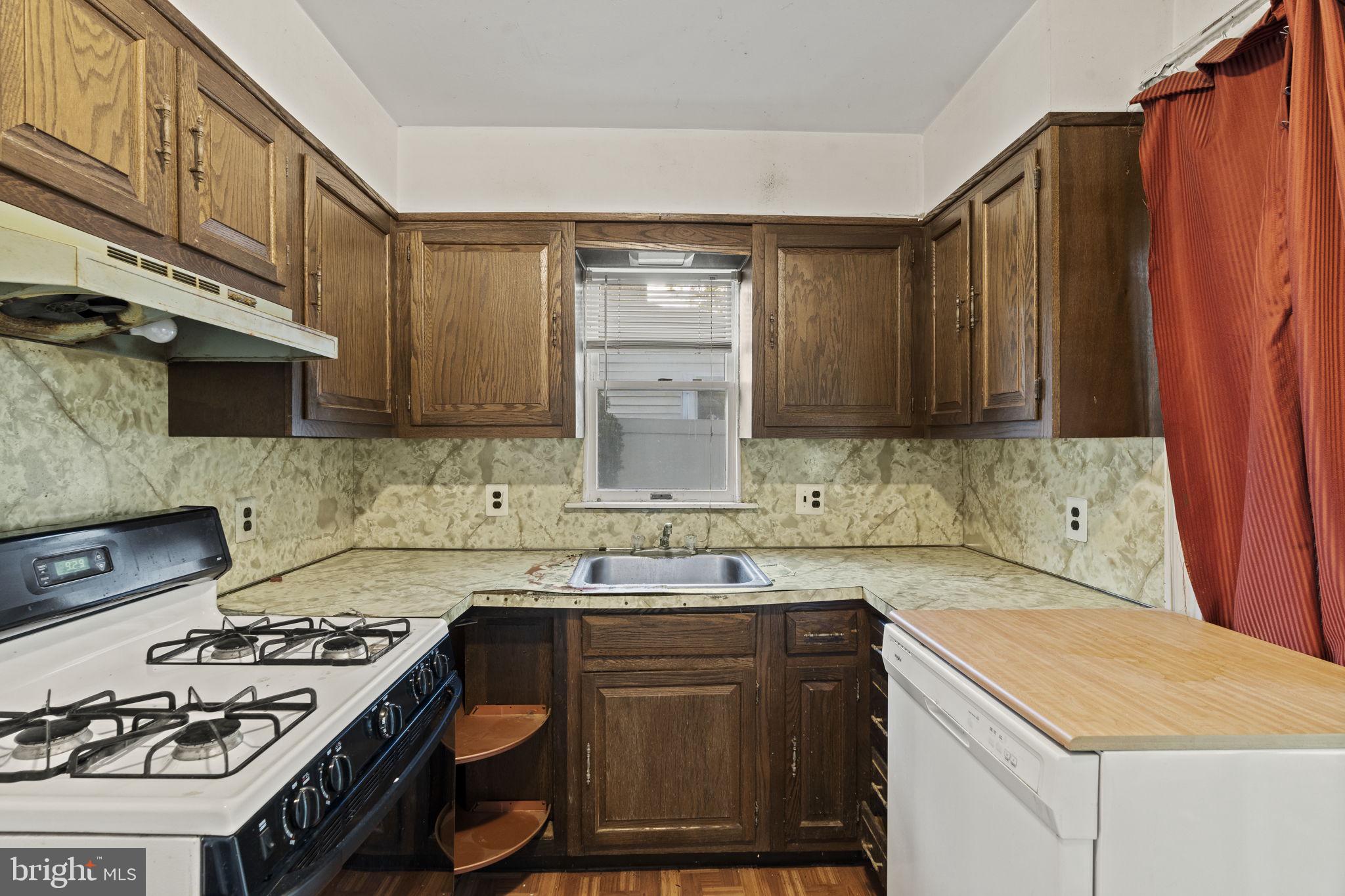 432 North Coles Avenue Maple Shade, NJ 08052 - Photo 9 of 27 a kitchen with a sink stove and cabinets