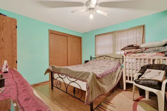 a bedroom with a bed and a chandelier