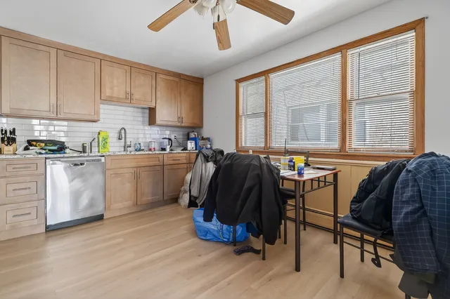 a kitchen with a sink cabinets and window