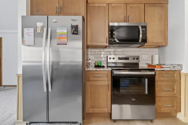 a kitchen with stainless steel appliances a stove a microwave and a refrigerator