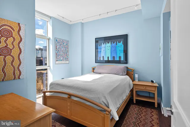 a bedroom with a bed and a window