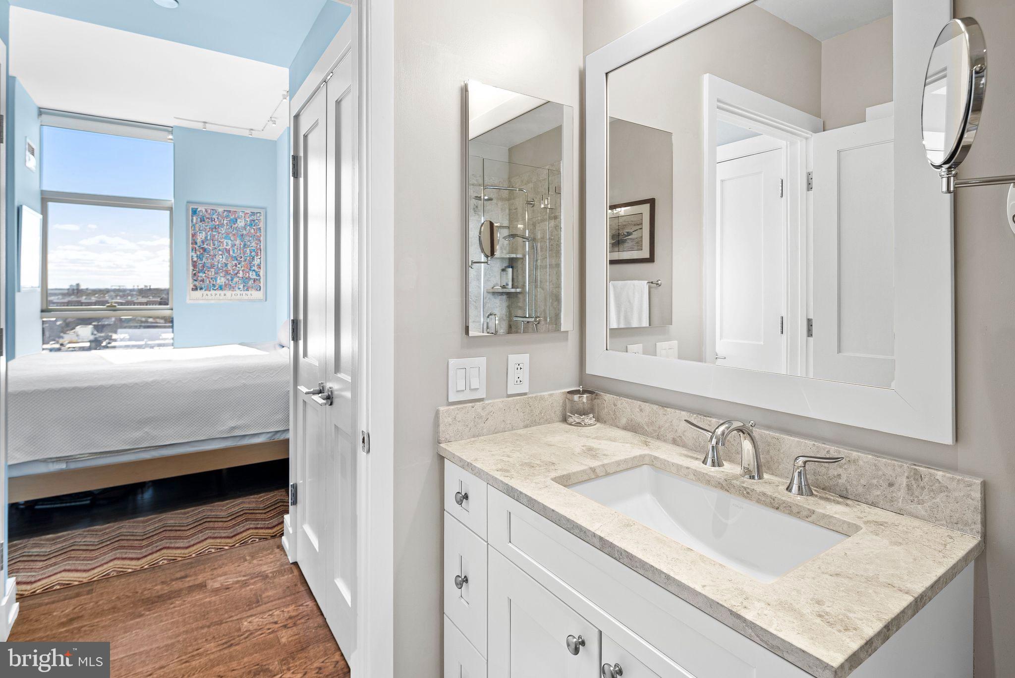 210 South 25th Street, Unit 905 Philadelphia, PA 19103 - Photo 15 of 28 a en suite bathroom with a granite countertop sink and a mirror