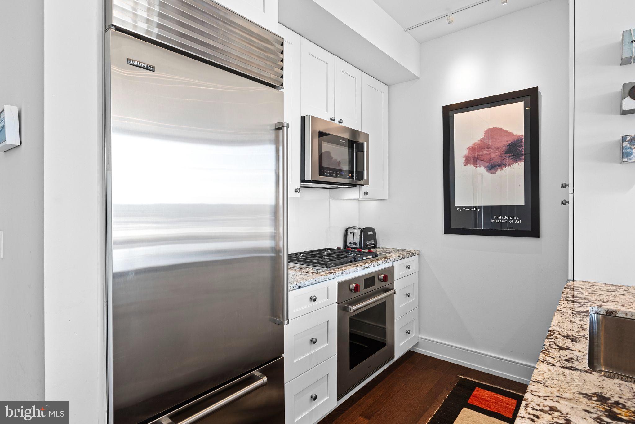 210 South 25th Street, Unit 905 Philadelphia, PA 19103 - Photo 4 of 28 a kitchen with a stove and a microwave