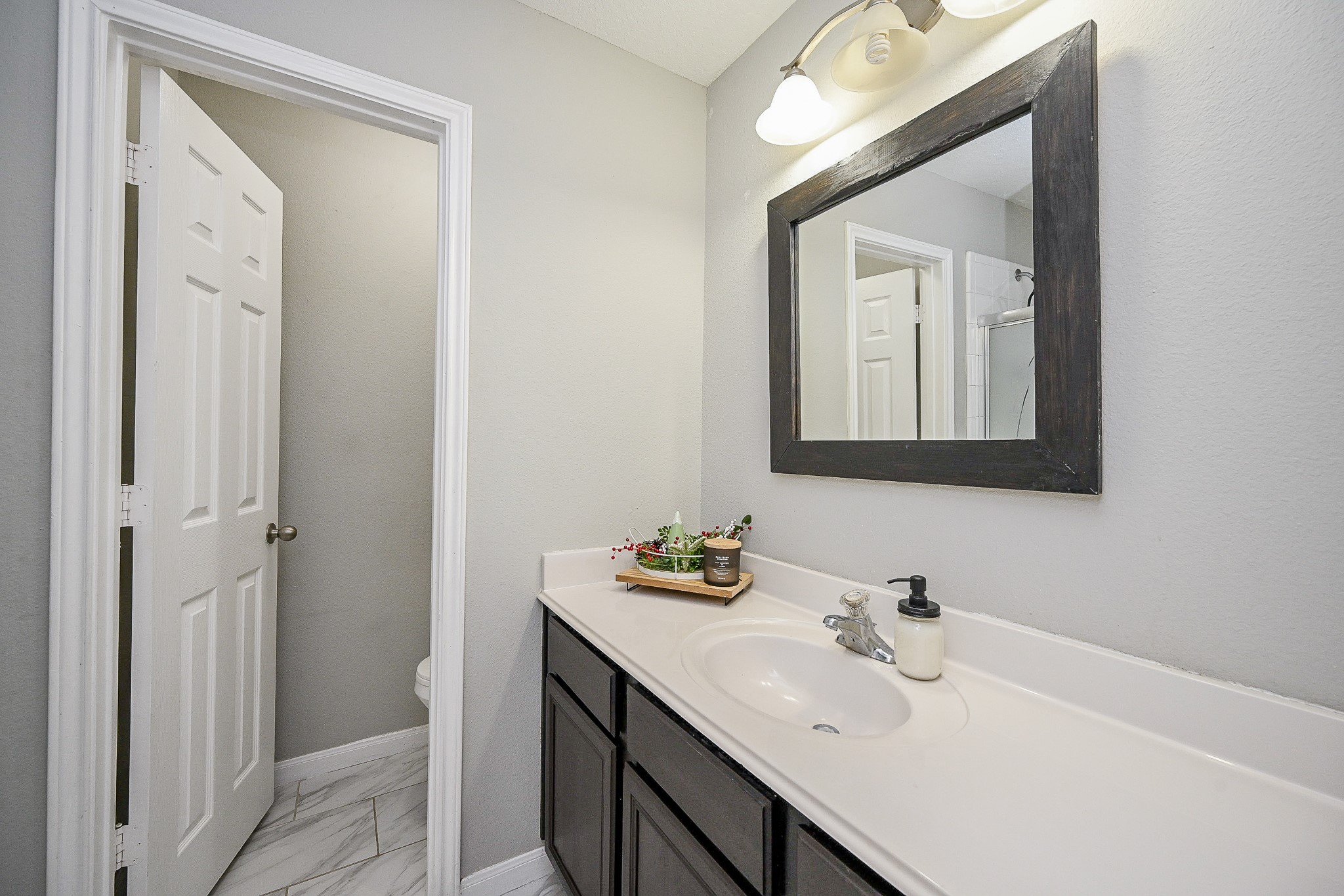 3907 Tigris Ridge Drive Katy, TX 77449 - Photo 16 of 20 a bathroom with a sink vanity and mirror
