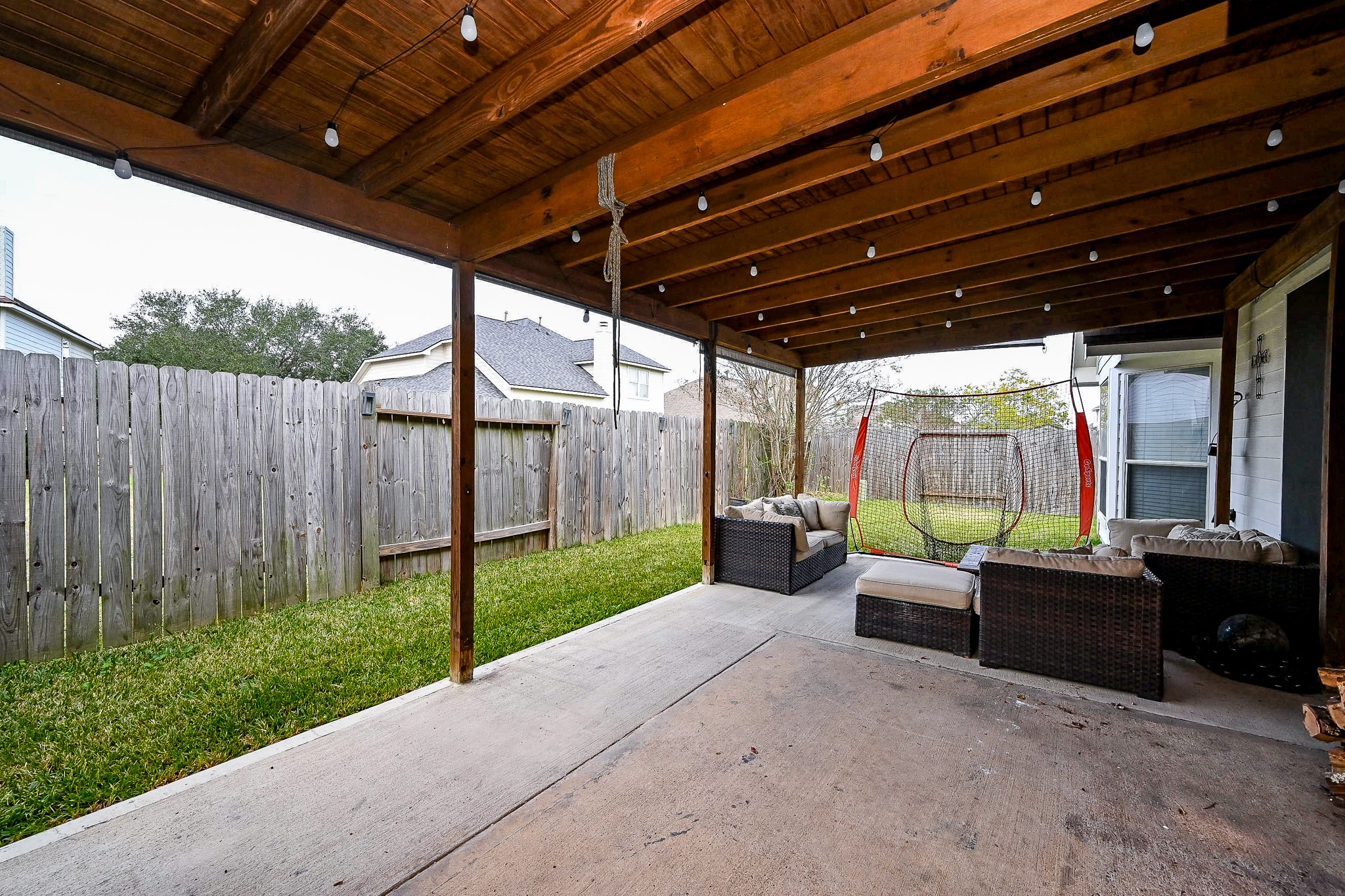 3907 Tigris Ridge Drive Katy, TX 77449 - Photo 19 of 20 a view of a backyard with couches plants and wooden fence