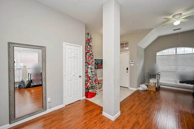 a view of a hallway and wooden floor and a livingroom