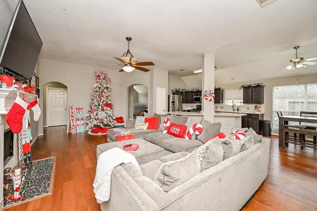a living room with lots of furniture and kitchen view
