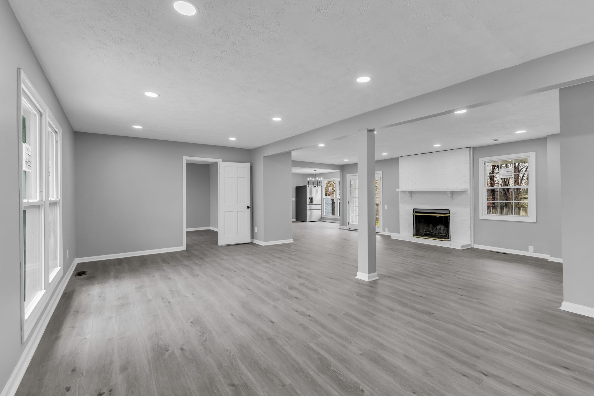 200 Upwind Court Nashville, TN 37217 - Photo 12 of 49 an empty room with wooden floor and fireplace