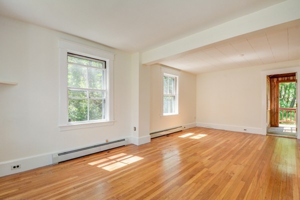 7 Martin Street Maynard, MA 01754 - Photo 12 of 28 a view of an empty room with wooden floor and a window