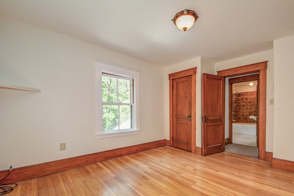7 Martin Street Maynard, MA 01754 - Photo 19 of 28 an empty room with window and wooden floor
