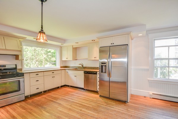 7 Martin Street Maynard, MA 01754 - Photo 5 of 28 a kitchen with granite countertop stainless steel appliances a stove sink and refrigerator