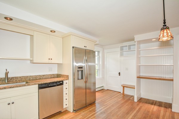 7 Martin Street Maynard, MA 01754 - Photo 6 of 28 a kitchen with a refrigerator and a wooden floor