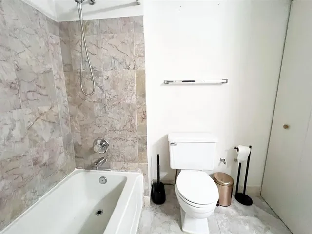a bathroom with a toilet and a bathtub