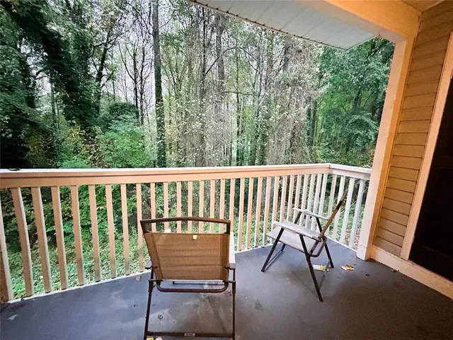 a view of a two chairs in the balcony