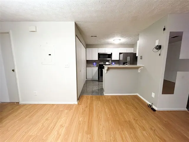 a kitchen with stainless steel appliances granite countertop a refrigerator stove and microwave