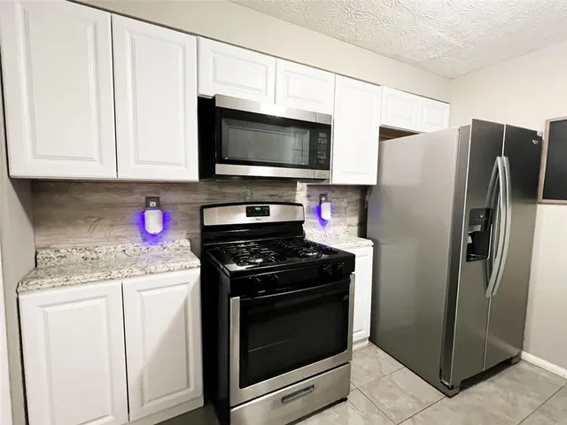 a kitchen with a sink a refrigerator and washer