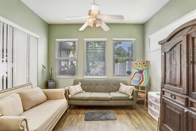 a living room with furniture and a chandelier