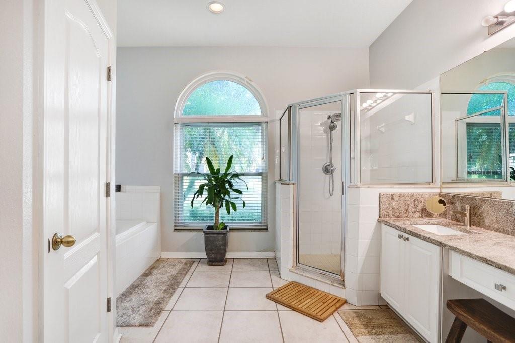 829 Innergary Place Valrico, FL 33594 - Photo 13 of 30 a bathroom with a tub and shower