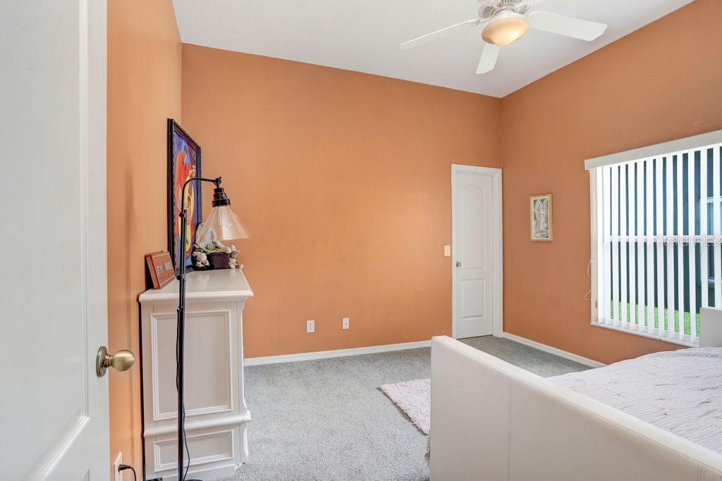 829 Innergary Place Valrico, FL 33594 - Photo 15 of 30 a bedroom with a bed and wooden floor