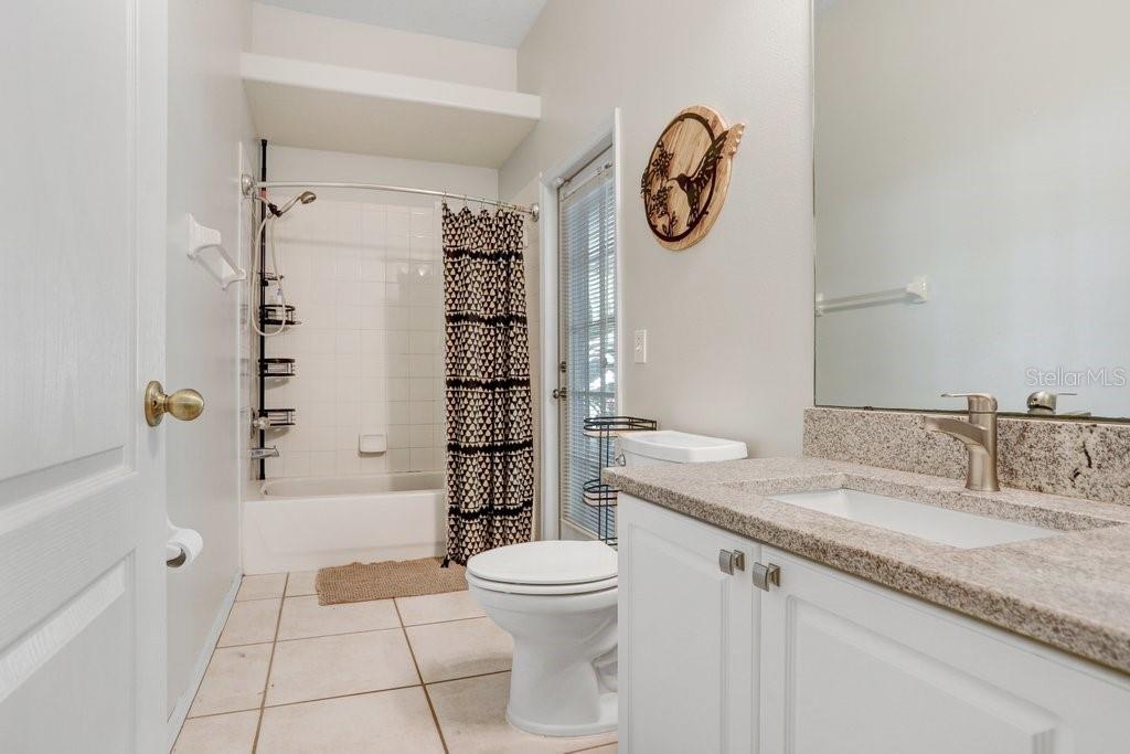 829 Innergary Place Valrico, FL 33594 - Photo 17 of 30 a bathroom with a granite countertop sink toilet and shower