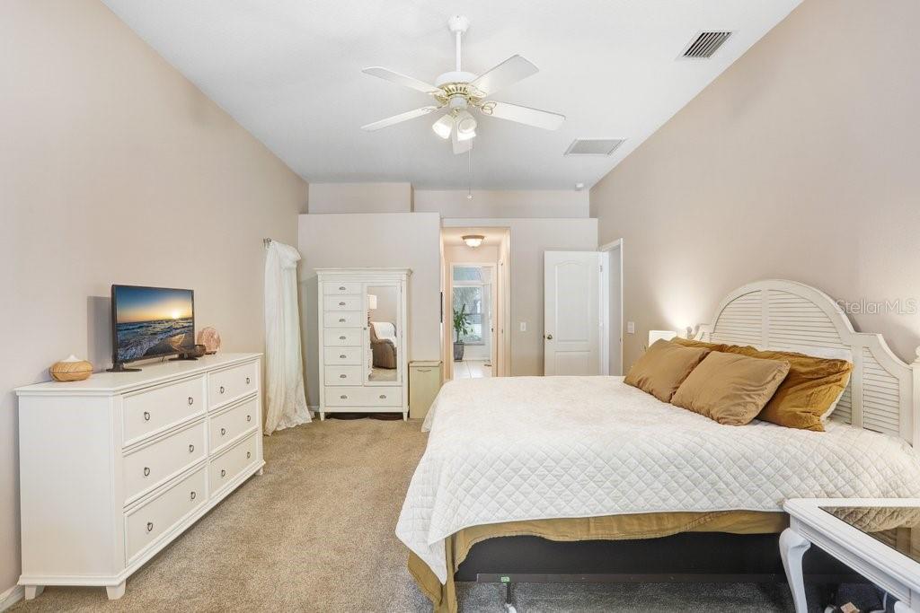 829 Innergary Place Valrico, FL 33594 - Photo 10 of 30 a bedroom with a bed and a flat screen tv