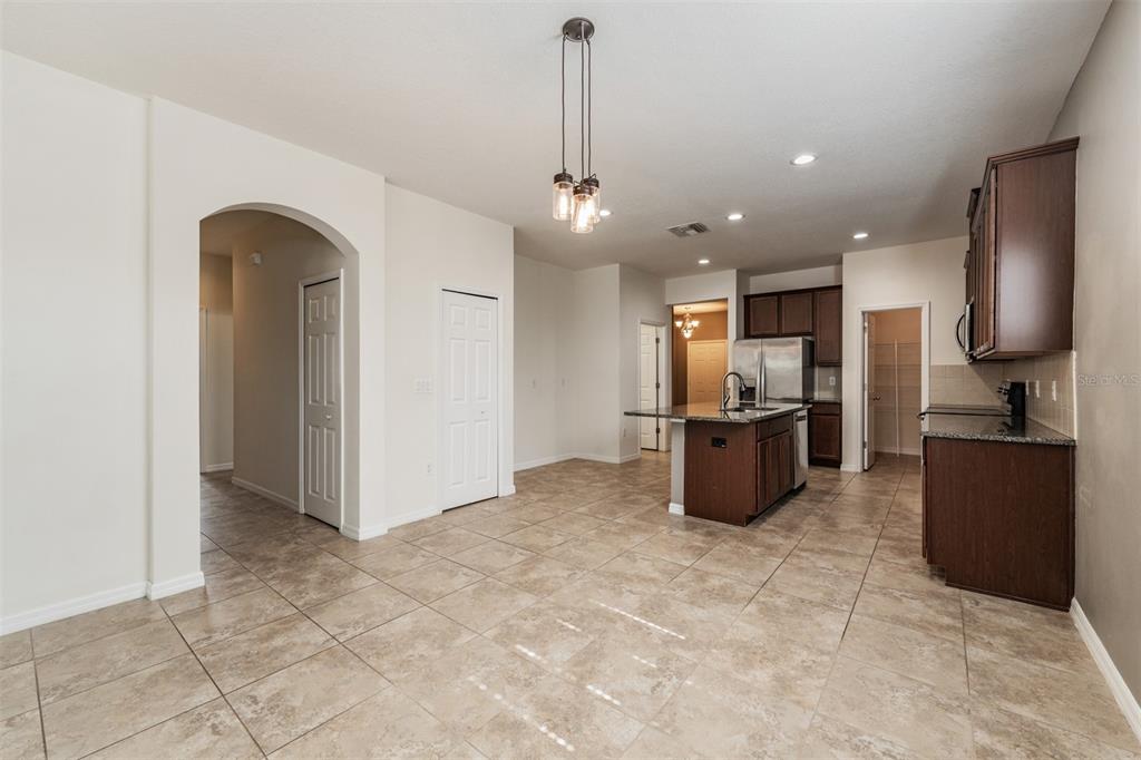 1570 Fox Grape Loop Lutz, FL 33558 - Photo 12 of 41 a kitchen with stainless steel appliances granite countertop a refrigerator a sink a stove and oven