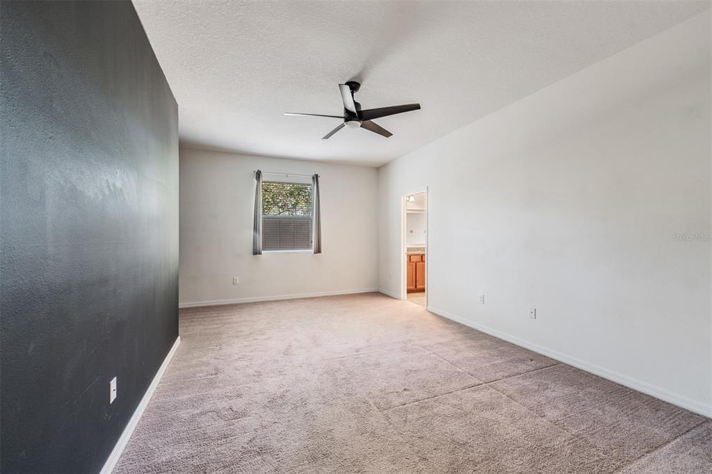 1570 Fox Grape Loop Lutz, FL 33558 - Photo 15 of 41 an empty room with windows and fan