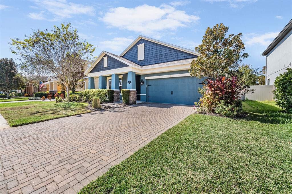 1570 Fox Grape Loop Lutz, FL 33558 - Photo 24 of 41 a front view of a house with a yard and potted plants