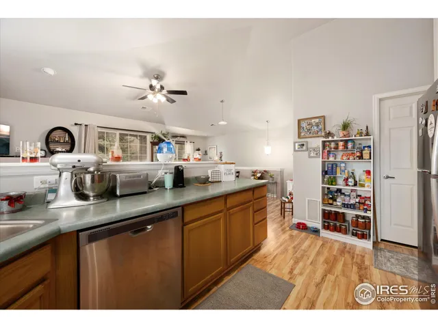 a kitchen with stainless steel appliances a refrigerator and a stove top oven